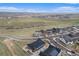 Panoramic aerial view of a neighborhood with houses, green spaces, and scenic mountain backdrop at 7877 Yampa River Ave, Littleton, CO 80125