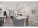 Open kitchen featuring an island with bar seating and views into the living area, perfect for entertaining at 7877 Yampa River Ave, Littleton, CO 80125