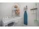 Well-equipped laundry room with washer, dryer, storage shelves, ironing board, and cleaning supplies at 7877 Yampa River Ave, Littleton, CO 80125