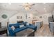Spacious living room featuring sleek wood floors, a sectional couch, and a stylish staircase at 7877 Yampa River Ave, Littleton, CO 80125
