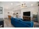 Open-concept living room with modern furnishings, a view into the adjacent kitchen at 7877 Yampa River Ave, Littleton, CO 80125