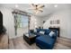 Cozy living room with a comfortable blue sectional, stylish decor, and natural light at 7877 Yampa River Ave, Littleton, CO 80125