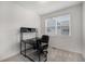 Bright home office with black desk and chair set and good natural light from the window at 7877 Yampa River Ave, Littleton, CO 80125
