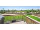 A deck with a built-in grill overlooks the fenced backyard with a green lawn and well-maintained landscaping at 8020 E 136Th Dr, Thornton, CO 80602
