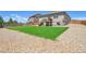 A large backyard is surrounded by a wooden fence, with a combination of lush grass and gravel at 8020 E 136Th Dr, Thornton, CO 80602