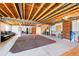 An unfinished basement with exposed ceilings and concrete flooring contains a workout area and recreational space at 8020 E 136Th Dr, Thornton, CO 80602