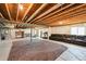 This unfinished basement with exposed ceilings and concrete flooring contains a workout area and lounge space at 8020 E 136Th Dr, Thornton, CO 80602
