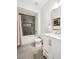 Bright bathroom featuring a combo tub and shower with neutral tile and a white vanity at 8020 E 136Th Dr, Thornton, CO 80602