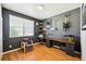Bedroom with hardwood floors, gray walls, an electric guitar, shelves and lots of natural light at 8020 E 136Th Dr, Thornton, CO 80602