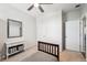 Bright bedroom featuring a ceiling fan, a light-colored carpet, neutral decor and 2 white doors at 8020 E 136Th Dr, Thornton, CO 80602
