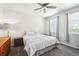 Comfortable bedroom with plush carpet, a ceiling fan, and natural light from the double windows at 8020 E 136Th Dr, Thornton, CO 80602