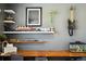 Close-up of a guitar and fish tank near desk with decor on shelves in a bedroom at 8020 E 136Th Dr, Thornton, CO 80602