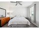 Neutral bedroom with plush carpet, a ceiling fan, and dresser with a mirror at 8020 E 136Th Dr, Thornton, CO 80602