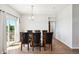 Well-lit dining room featuring a glass table, seating for six, and modern chandelier at 8020 E 136Th Dr, Thornton, CO 80602