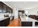 Spacious kitchen featuring stainless steel appliances, dark cabinetry, and bright quartz countertops at 8020 E 136Th Dr, Thornton, CO 80602