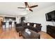 Open concept living room featuring hardwood floors, comfortable couch, and a kitchen island with bar seating at 8020 E 136Th Dr, Thornton, CO 80602
