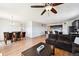Open concept living room featuring hardwood floors, comfortable couch, dining area and a view of the kitchen at 8020 E 136Th Dr, Thornton, CO 80602