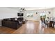 Spacious living room featuring hardwood floors, a comfortable couch, and a dining area with sliding glass doors at 8020 E 136Th Dr, Thornton, CO 80602