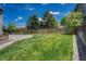 Backyard with grassy lawn, gravel area, and wooden fence at 10174 Fawnbrook Ln, Highlands Ranch, CO 80130