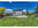 Large backyard with a grassy area and a wooden fence at 10174 Fawnbrook Ln, Highlands Ranch, CO 80130