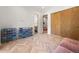 Bright bedroom with wood herringbone flooring, storage, access to a bathroom, and closet with wood sliding doors at 365 Bow Mountain Rd, Boulder, CO 80302