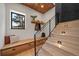 Bright entryway features custom bench seating, built-in storage, modern staircase, and black brick accent wall at 365 Bow Mountain Rd, Boulder, CO 80302