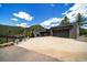 Modern home showcasing a large driveway, a two-car garage, and views of the mountainous forest backdrop at 365 Bow Mountain Rd, Boulder, CO 80302