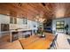 Open-concept kitchen boasts white cabinets, large island with bar seating, and adjacent dining area with fireplace at 365 Bow Mountain Rd, Boulder, CO 80302
