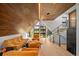 Modern living room featuring vaulted wood ceilings, large windows with mountain views, and stylish furniture at 365 Bow Mountain Rd, Boulder, CO 80302