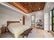 Serene main bedroom boasts wood accents, neutral tones, and seamless flow to an adjacent ensuite bathroom at 365 Bow Mountain Rd, Boulder, CO 80302