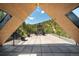 Striking outdoor patio with mountain views features a stone fireplace and seating framed by modern architecture at 365 Bow Mountain Rd, Boulder, CO 80302