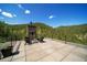 Outdoor patio with fireplace and seating offers mountain views and creates a relaxing ambiance for outdoor living at 365 Bow Mountain Rd, Boulder, CO 80302