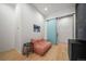 A bright sitting room with wood floors, peach lounge seating, modern barn door, and stylish modern decor at 365 Bow Mountain Rd, Boulder, CO 80302