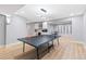 Finished basement with ping pong table, kitchenette, and entertainment area, perfect for recreation and relaxation at 5722 S Benton Way, Littleton, CO 80123
