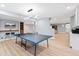 Finished basement featuring a ping pong table, bar seating, and open layout at 5722 S Benton Way, Littleton, CO 80123
