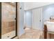 Bathroom showcasing a tiled shower, vanity, and neutral color scheme at 5722 S Benton Way, Littleton, CO 80123
