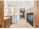 Elegant bathroom with tiled floor, dual sink vanity, fireplace, and closet access for added convenience at 5722 S Benton Way, Littleton, CO 80123