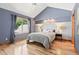 Bedroom features a ceiling fan, hardwood floors, and a large window that provides natural light to the space at 5722 S Benton Way, Littleton, CO 80123