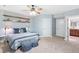 Cozy bedroom with a ceiling fan, soft carpet, and decorative floating shelves at 5722 S Benton Way, Littleton, CO 80123