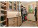 Walk-in closet featuring custom wood cabinets and shelves with ample space to store all your wardrobe needs at 5722 S Benton Way, Littleton, CO 80123