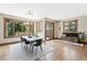 Inviting dining room with outdoor access, modern lighting, and views of the landscaped backyard at 5722 S Benton Way, Littleton, CO 80123