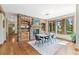 Elegant dining room with stone accent wall, fireplace, and large windows overlooking the backyard at 5722 S Benton Way, Littleton, CO 80123