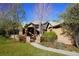 Charming stucco home with stone accents, mature trees, and a welcoming front walkway at 5722 S Benton Way, Littleton, CO 80123
