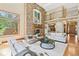 Cozy living room with a floor to ceiling stone fireplace and large windows showcasing outdoor views at 5722 S Benton Way, Littleton, CO 80123