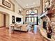 A spacious living room boasts vaulted ceilings, a stone fireplace, and large windows showcasing scenic views at 5722 S Benton Way, Littleton, CO 80123