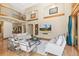 Spacious living room with a high ceiling, stylish furniture, and a balcony at 5722 S Benton Way, Littleton, CO 80123