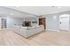 Spacious living area has a stone fireplace, TV, wood floors, and a walkout at 5722 S Benton Way, Littleton, CO 80123