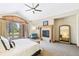 Bright, spacious main bedroom boasts a fireplace, ceiling fan, and private patio access at 5722 S Benton Way, Littleton, CO 80123