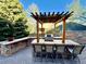 Outdoor kitchen with a built-in grill, counter space, and bar seating at 5722 S Benton Way, Littleton, CO 80123