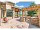 Covered outdoor kitchen area complete with a grill, counter, and comfortable seating at 5722 S Benton Way, Littleton, CO 80123